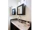 Updated bathroom vanity with a white marble countertop, modern faucet, and decorative mirror at 1340 Elkhart Cir, Tavares, FL 32778