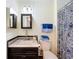 Neatly organized bathroom with a stylish vanity, modern fixtures, and a patterned shower curtain at 1340 Elkhart Cir, Tavares, FL 32778