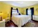 Bright bedroom featuring hardwood floors, natural lighting, and a comfortable queen-sized bed at 1340 Elkhart Cir, Tavares, FL 32778