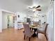 Cozy dining area with a glass-top table, complemented by a ceiling fan and natural light at 1340 Elkhart Cir, Tavares, FL 32778