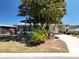 Charming home with mature trees, landscaped front yard, and a welcoming facade at 1340 Elkhart Cir, Tavares, FL 32778