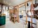 An unfinished garage featuring a workbench, pegboard, storage, and a view through to another room at 1340 Elkhart Cir, Tavares, FL 32778