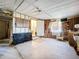 Unfinished garage space featuring exposed wood beams, a storage dresser, and a bright window at 1340 Elkhart Cir, Tavares, FL 32778