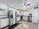 Modern kitchen featuring stainless steel appliances, white cabinets, black countertop, and plenty of storage space at 1340 Elkhart Cir, Tavares, FL 32778