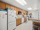 This community kitchen features basic appliances, wooden cabinets, and ample counter space at 1340 Elkhart Cir, Tavares, FL 32778