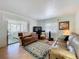 Cozy living room showcasing comfortable seating, a TV, and natural light through draped windows at 1340 Elkhart Cir, Tavares, FL 32778