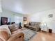 Inviting living room features comfortable seating, a decorative rug, and soft natural light at 1340 Elkhart Cir, Tavares, FL 32778