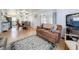 Cozy living room featuring wood floors, comfortable seating, and seamless flow into the dining area and kitchen at 1340 Elkhart Cir, Tavares, FL 32778