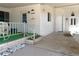 Charming front porch with a white wicker rocking chair and inviting entrance to the home at 1340 Elkhart Cir, Tavares, FL 32778
