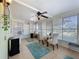 A sunroom offering natural light through large windows, with tile flooring, ceiling fan, a table and chairs at 1340 Elkhart Cir, Tavares, FL 32778