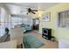 Bright and airy sunroom featuring large windows, a ceiling fan, comfortable seating, and a tranquil space to relax at 1340 Elkhart Cir, Tavares, FL 32778