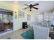 Bright sunroom featuring tile floors, a ceiling fan, and an adjoining living area at 1340 Elkhart Cir, Tavares, FL 32778