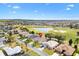 Lovely aerial view of home in golf community, featuring lush landscaping and serene lake views at 1380 Mayesville Way, The Villages, FL 32162