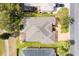 Aerial view of house with neutral roof, screened-in patio, next to golf course at 1380 Mayesville Way, The Villages, FL 32162