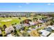 Lovely aerial view of home in golf community, featuring lush landscaping and serene lake views at 1380 Mayesville Way, The Villages, FL 32162