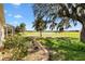Stunning backyard view overlooking the golf course with mature landscaping and plenty of sunshine at 1380 Mayesville Way, The Villages, FL 32162