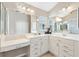 Bathroom with dual sinks, quartz countertops, and ample mirror space at 1380 Mayesville Way, The Villages, FL 32162