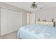Bedroom featuring a bed with blue and white quilt, large closet, and bright paint at 1380 Mayesville Way, The Villages, FL 32162