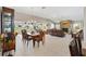 Open concept dining and living area with a stone fireplace and tile flooring at 1380 Mayesville Way, The Villages, FL 32162