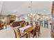 Bright dining area connected to the living room and featuring a stone fireplace at 1380 Mayesville Way, The Villages, FL 32162