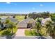 Charming single-story home with attached garage, manicured lawn, and beautiful palm tree landscaping at 1380 Mayesville Way, The Villages, FL 32162