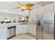 Kitchen featuring stainless steel appliances, tile backsplash and a breakfast bar overlooking the Gathering room at 1380 Mayesville Way, The Villages, FL 32162