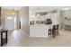 Bright kitchen featuring white cabinets, modern appliances and tile flooring at 1380 Mayesville Way, The Villages, FL 32162