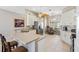 Open-concept kitchen featuring stainless steel appliances and a breakfast bar with seating at 1380 Mayesville Way, The Villages, FL 32162