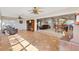 Open concept living room with tile floors, ceiling fans, living room, and dining room visible at 1380 Mayesville Way, The Villages, FL 32162