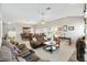 Spacious living room with tile floors, comfortable seating, and ample natural light at 1380 Mayesville Way, The Villages, FL 32162