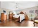Main bedroom with hardwood floors, a ceiling fan, and windows for natural light at 1380 Mayesville Way, The Villages, FL 32162