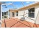 Screened in patio with nice view, concrete floors, and an outdoor bench at 1380 Mayesville Way, The Villages, FL 32162