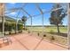 Screened in patio with golf course view, decorative stone, and nice seating at 1380 Mayesville Way, The Villages, FL 32162
