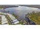 Aerial view of waterfront homes with private docks on a lake community, offering stunning water access at 1401 W Highway 50 # 173, Clermont, FL 34711