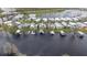 Aerial view displays waterfront community homes with boat docks on a dark lake at 1401 W Highway 50 # 173, Clermont, FL 34711