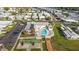 Aerial view of a community center featuring a pool, shuffleboard courts, and well-manicured grounds at 1401 W Highway 50 # 173, Clermont, FL 34711