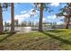 Picturesque backyard with a covered dock overlooking the serene lake and lush greenery at 1401 W Highway 50 # 173, Clermont, FL 34711