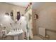Bright bathroom featuring a pedestal sink and shower with palm-themed curtains at 1401 W Highway 50 # 173, Clermont, FL 34711