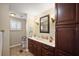 Bathroom with cherry wood vanity, neutral countertops, and modern fixtures at 1401 W Highway 50 # 173, Clermont, FL 34711
