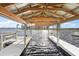 Covered boat dock featuring a white wooden pier and exposed beams, overlooking the sparkling water at 1401 W Highway 50 # 173, Clermont, FL 34711