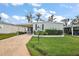 Charming single-story home with manicured lawn, carport, and well-maintained landscaping at 1401 W Highway 50 # 173, Clermont, FL 34711
