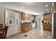 Well-lit kitchen with extensive wood cabinetry, granite countertops, and tiled floors at 1401 W Highway 50 # 173, Clermont, FL 34711