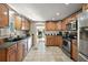 Spacious kitchen featuring wood cabinets, granite countertops, and stainless steel appliances at 1401 W Highway 50 # 173, Clermont, FL 34711
