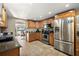 Bright kitchen with ample wood cabinetry, granite counters, and modern stainless steel appliances at 1401 W Highway 50 # 173, Clermont, FL 34711