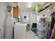 Well-organized laundry room with washer, storage shelves, and ample space at 1401 W Highway 50 # 173, Clermont, FL 34711