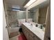 Functional bathroom with a vanity, mirror, and shower-tub combination at 146 Jacaranda Dr, Leesburg, FL 34748