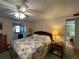 Cozy bedroom with a comfortable bed, stylish decor, and convenient access to the bathroom at 146 Jacaranda Dr, Leesburg, FL 34748