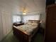 Relaxing bedroom featuring comfortable bed, a ceiling fan, and windows with natural light at 146 Jacaranda Dr, Leesburg, FL 34748