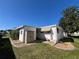 Exterior view of the home featuring a storage shed, tidy yard, and well-maintained landscaping at 146 Jacaranda Dr, Leesburg, FL 34748