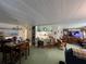 Open-concept living space featuring a dining area, breakfast bar, and comfortable seating at 146 Jacaranda Dr, Leesburg, FL 34748